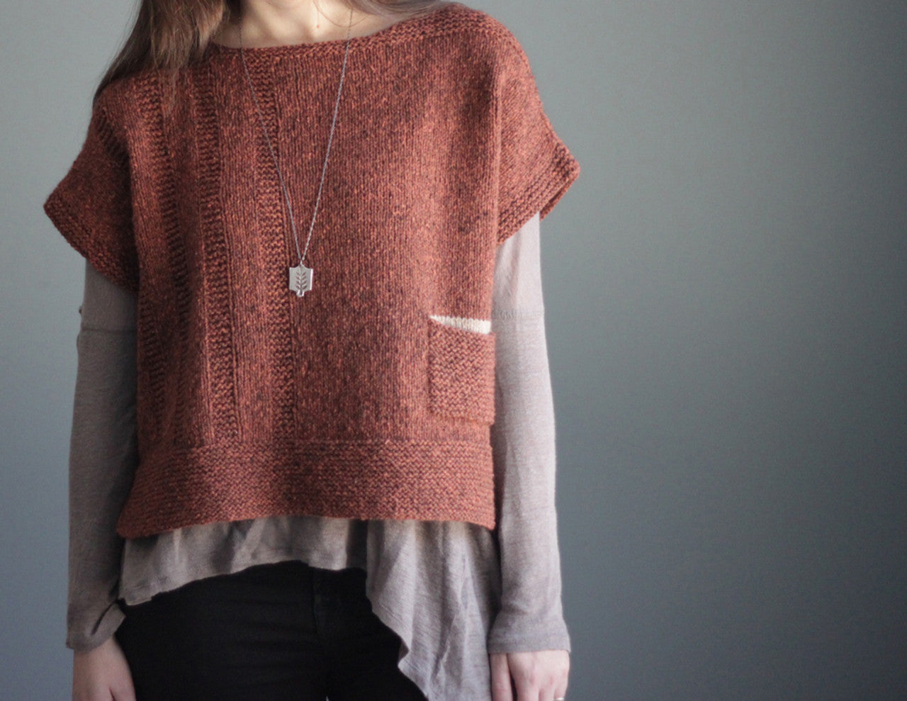 ALANIS SWEATER TEE by Elizabeth Smith Knits - 28-62" chest - Worsted weight solid with a contrast left pocket - uses 796-1766 yds wstd main 30 yds contrast pocket