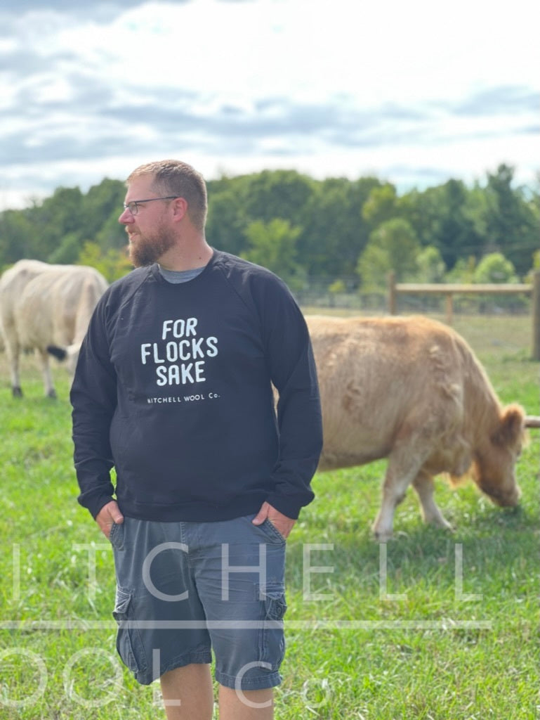 sunwashed sunny pastures, Luke standing in the foreground with the cattle in the back.