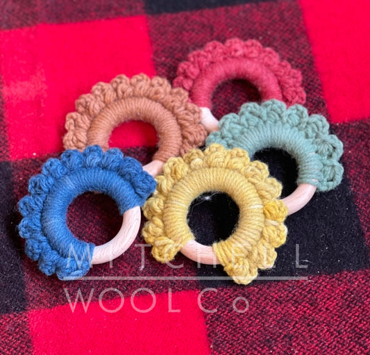 Crocheted around a birch ring, these hand made teethers look like the marigolds we grow to dye our yarn