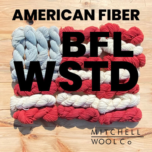 an American flag composed of yarn with the words American Fiber BFL wstd in black on the surfaces.