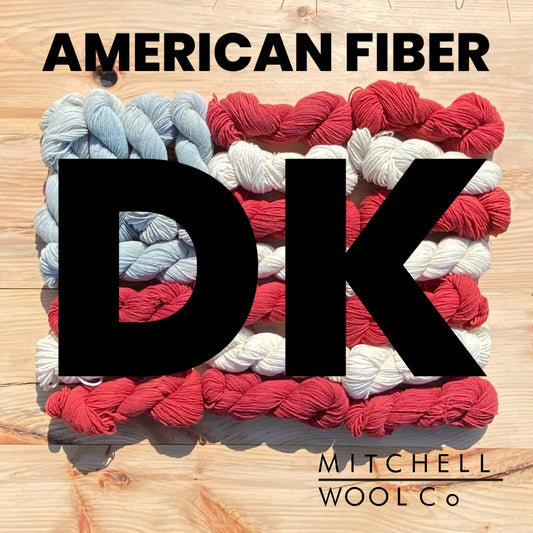 an American flag composed of yarn with the words American Fiber DK in black on the surfaces.