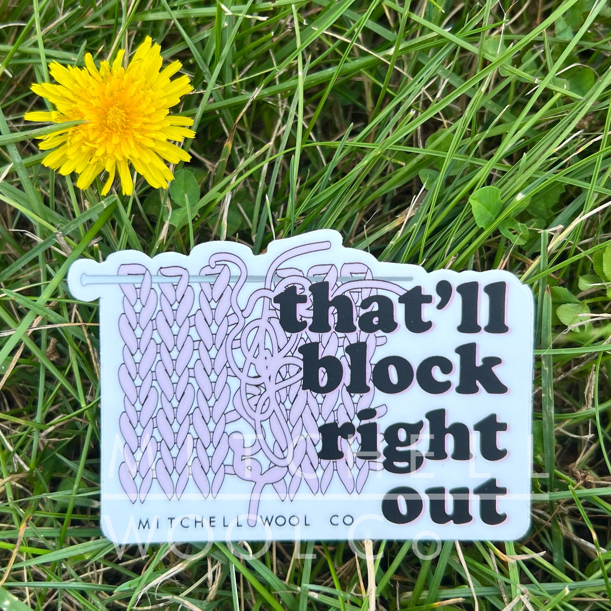 2.5 x 4.0" sticker with black and lavender text, "that'll block right out" with a knitting needle and yarn in the background.