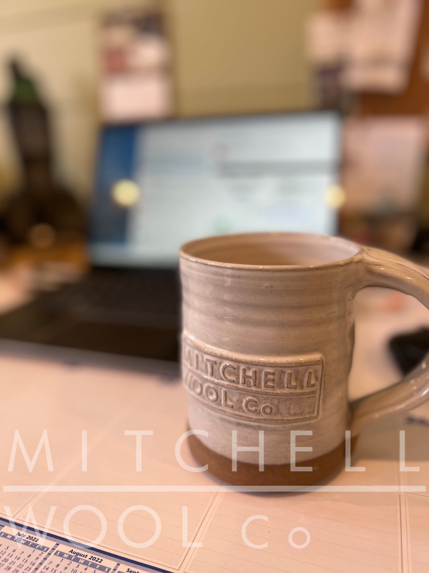 Sherry's own MWC mug sits in front of the work lap top distracting her from the day's tasks at hand because of it's stunning beauty. The glaze beautifully highlights the soft rings around the body and compliments the raw pottery bottom. The inside is fully glazed.