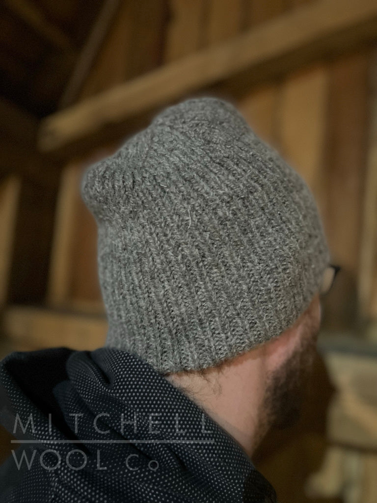 Luke looks longingly at that gorgeous 19th century barn. He wishes the chores would do themselves while he contemplates the stunning and cozy hat that he is wearing made of Farm Friends yarn.