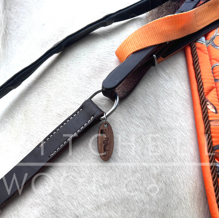 Whiskey's oval tag fits securely on the D ring of his breast plate 